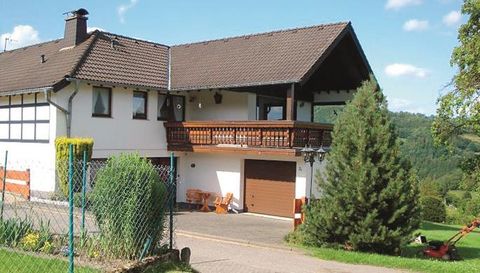 A cozy house with a balcony and a garage.
Surrounded by green countryside and a beautiful garden.