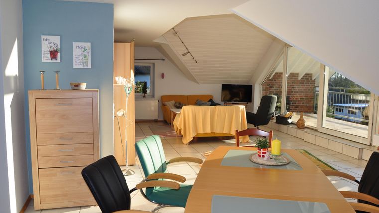 A bright and cozy attic apartment with modern furnishings. The dining area offers a beautiful view of the surroundings.