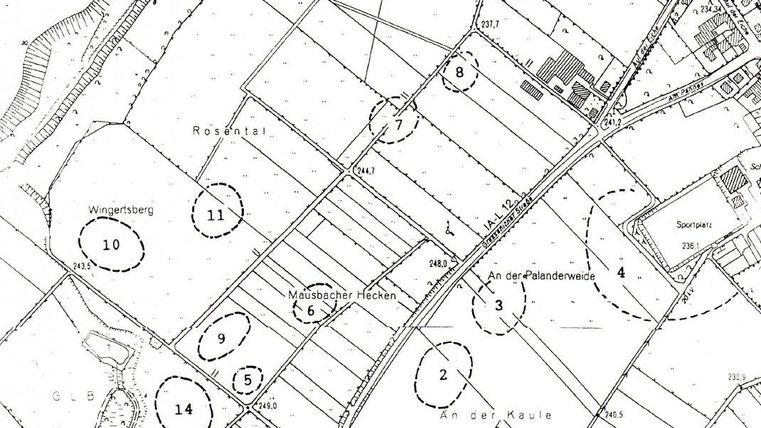A schematic representation of an area with numbered fields and roads. The map shows different land uses and geographical features.