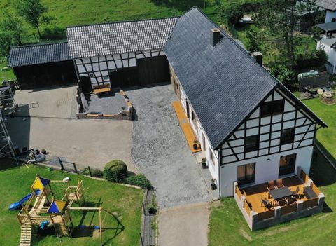 A beautiful farmhouse with a large garden and a playground. The terrace invites you to relax outdoors.