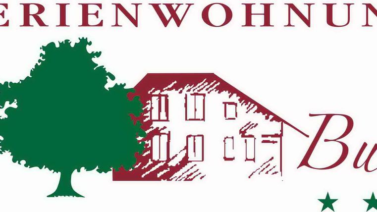 A logo for a holiday apartment called "Zur Buche". It features a house with a tree and three stars.