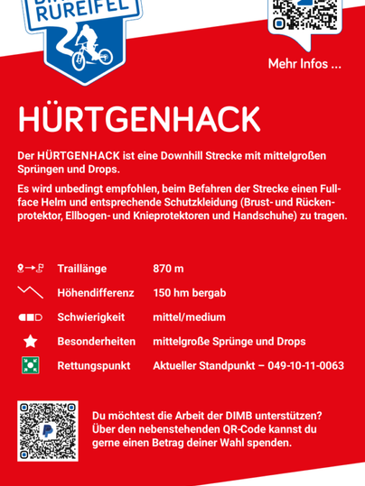 An information sign for the downhill track "Hürtegnhack" in the Bikepark Rureifel. It contains details about the track length, difficulty, and safety requirements.