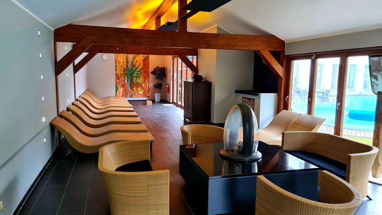 A modern interior with comfortable furniture and large windows. The atmosphere is bright and inviting.