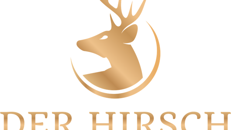 An elegant logo featuring a stylized deer head in gold tones. Below it is the text “DER HIRSCH HOTEL·APARTMENT” written in clear font.
