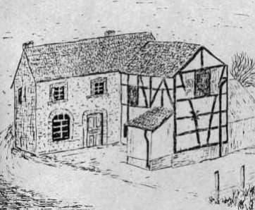 A historic house with a stone facade and a half-timbered building next to it. The surroundings seem rural and simple.