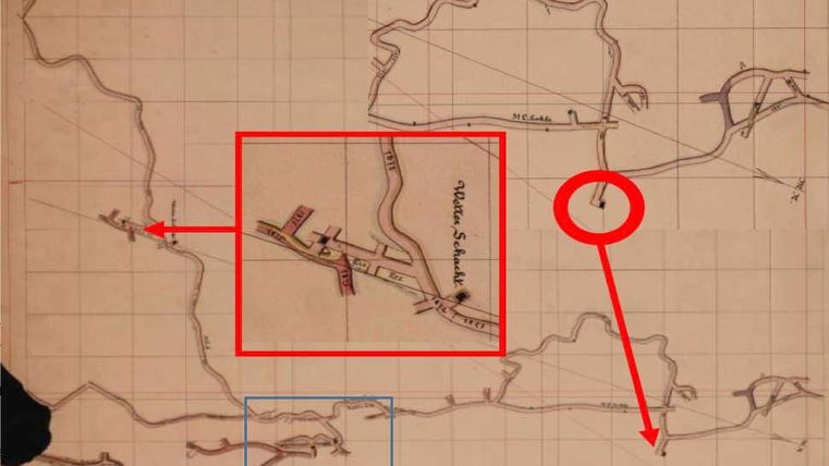 A historical map with various lines and markings. Areas are highlighted in red and blue boxes.