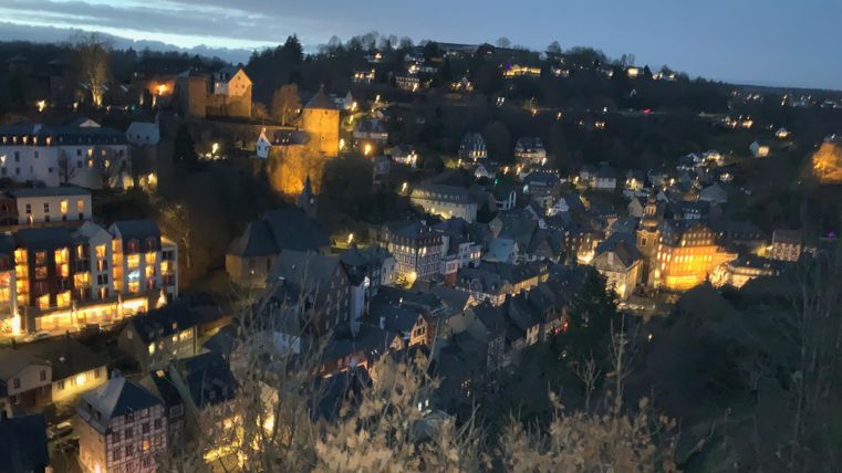 A beautiful city view at night. The lights of the buildings sparkle in the dark, creating a picturesque atmosphere.