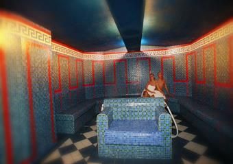 An idyllic space with blue mosaic walls and a cozy seating area. Two people relax in a quiet atmosphere.