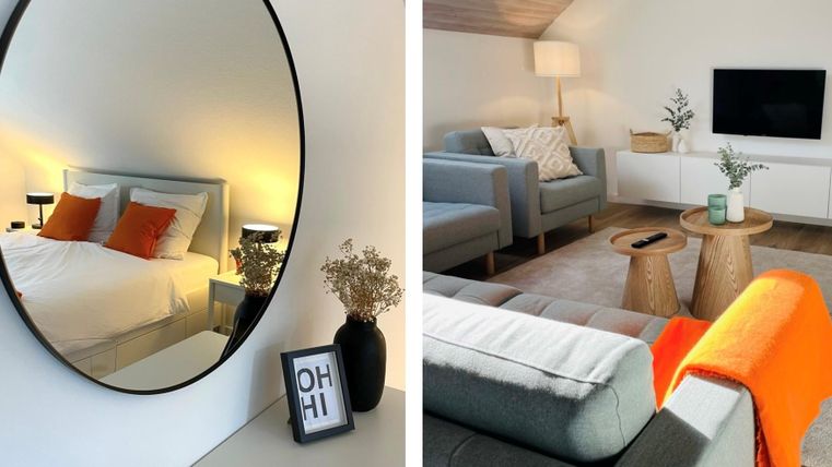 Een stijlvolle slaapkamer met een grote spiegel en een comfortabel bed. In de woonkamer staan moderne meubels en decoratieve elementen.